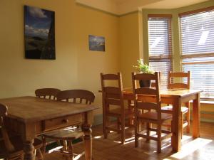 a dining room table with chairs and a window at Llangollen Hostel in Llangollen