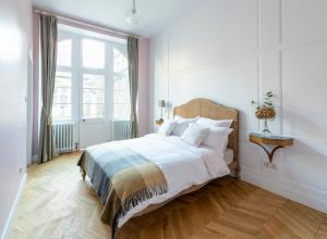 a bedroom with a bed and a large window at The Stay Well in Boulogne-sur-Mer