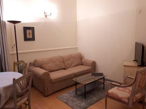 a living room with a couch and a table at Appartement 7 Château des Gipières in Montbrun-les-Bains