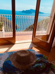 a straw hat sitting on the floor in front of a door at Acquamarina Accommodation in Massa Lubrense