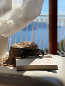 a hat and glasses sitting on top of a book at Acquamarina Accommodation in Massa Lubrense