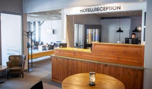 a hotel lobby with a reception desk and a table at Bergshotellet in Järvsö