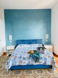 a blue bedroom with a bed with a blue wall at Acquamarina Accommodation in Massa Lubrense