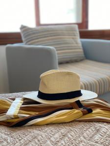 a hat sitting on top of a bed at Acquamarina Accommodation in Massa Lubrense