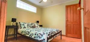a bedroom with a bed and a window at Treetops Hideaway Albury in Albury
