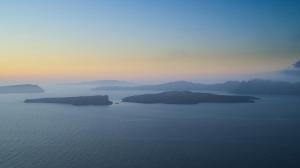 a group of islands in the water at sunset at Melidonia Suites in Akrotiri