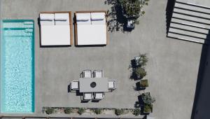 an overhead view of a swimming pool with a house at Melidonia Suites in Akrotiri