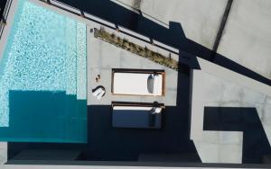 a bathroom with a window and a blue door at Melidonia Suites in Akrotiri