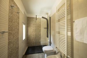 a bathroom with a toilet and a shower at La Togata Hotellerie de Charme Relais il Terrazzo in Montalcino +31 photos