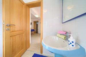a bathroom with a sink and a mirror at Apartman ANTICA in Vantačići +11 photos