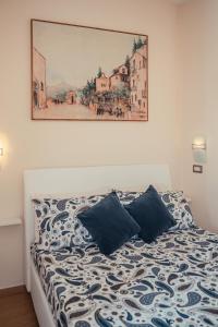 a bedroom with a bed with a painting on the wall at B&B Floridia in Taormina