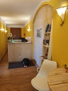 a cat is sitting on the floor in a kitchen at Pension Maria in Antdorf