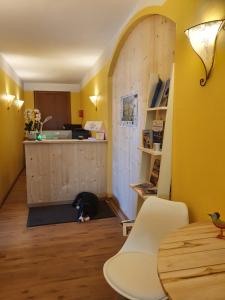 a cat is sitting on the floor in a kitchen at Pension Maria in Antdorf +20 photos