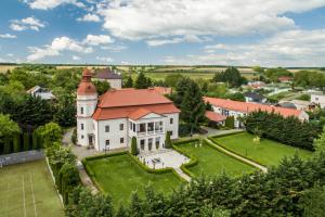 an aerial view of a large white house with a red roof at Kaštieľ Penzion in Rimavská Sobota