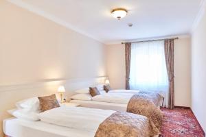 Postel nebo postele na pokoji v ubytování Spa Hotel Centrum