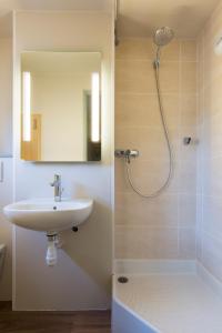 a bathroom with a sink and a shower at B&B HOTEL Rouen Centre in Rouen