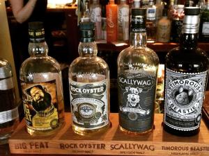 a group of bottles of alcohol sitting on a shelf at The Holcombe in Holcombe