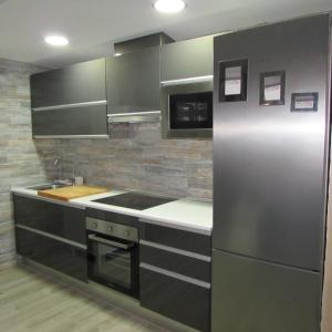 a kitchen with a stainless steel refrigerator and a sink at GARRUCHA HOME AND BEACH in Garrucha