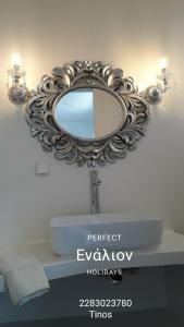 a bathroom with a mirror over a sink at ENALION-TINOS in Tinos Town