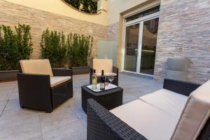 a patio with chairs and a table with wine bottles at Il Valentino Luxury Houses in Florence