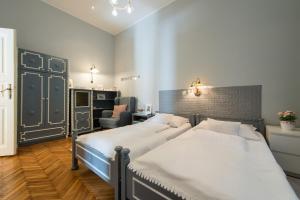 ブダペストにあるCity Heart Apartmentsのベッドルーム1室(ツインベッド2台、椅子付)