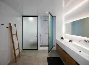 a bathroom with a sink and a mirror at Melidonia Suites in Akrotiri