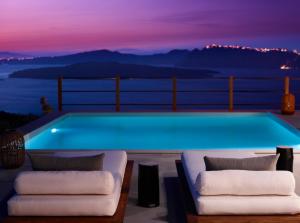 a pool on the deck of a house at Melidonia Suites in Akrotiri