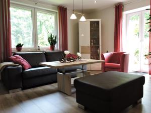 a living room with a couch and a table at Apartment Am Anker in Uchte