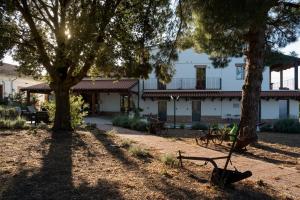 a park with benches and trees in front of a building at Casetta Don Carlino in Campomarino