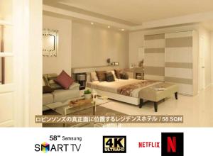 a bedroom with a bed and a couch in a room at The Sriracha Residence in Si Racha