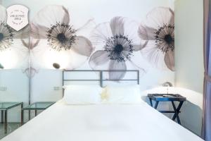 a bedroom with a bed with flowers on the wall at Il Convento Dei Fiori Di Seta in Bologna