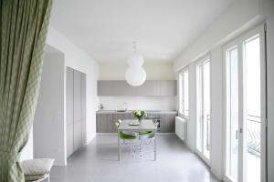 a kitchen with a table with flowers on it at IseoLakeRental - La Villina - Zù in Riva di Solto