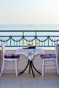 a table and two chairs with wine glasses on it at Villa Lavanda in Podgora
