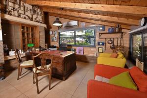 a living room with a desk and a table and chairs at Out of Africa Resort in Had Nes