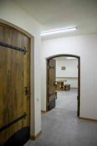 an empty room with two wooden doors and a table at Tatev Hotel and Tours in Yerevan