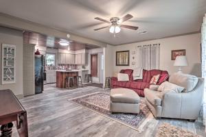 a living room with a couch and a ceiling fan at Lake Charles Home 1 Mi to Public Boat Launch in Lake Charles