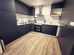 
a kitchen with a refrigerator, stove, sink and cabinets at Hostel One Sants in Barcelona
