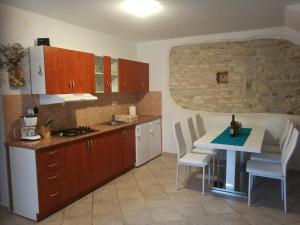 a kitchen with a table and a table and a kitchen with a stove at Villa Piazza grande in Fažana
