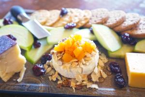 a plate of food with cheese crackers and fruit at Firehouse Campground in Hill City