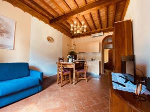 a living room with a blue couch and a table at Casa Teatro in Cortona