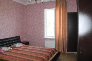 a bedroom with a bed and a window at Hotel Villa Oasis in Kobuleti