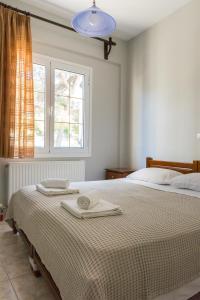 Postel nebo postele na pokoji v ubytování Vasilis Apartments