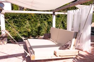 a porch swing with a white canopy and two chairs at SunVilla with hot tub in Koper