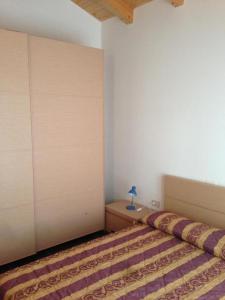 a bedroom with a large bed with a wall at Residence Antares in Caorle