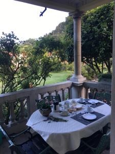 a table with a white table cloth on a porch at il Motto di Tommy in Castelveccana