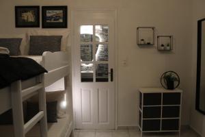 a bedroom with two bunk beds and a door at Cycladic Villa in Amorgos Island (Maison Shiro) in Arkesíni