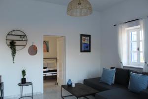 a living room with a couch and a table at Cycladic Villa in Amorgos Island (Maison Shiro) in Arkesíni