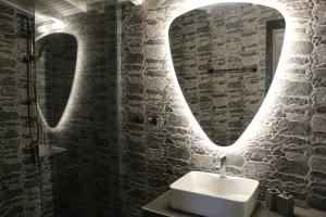 a bathroom with a sink and a mirror at Cycladic Villa in Amorgos Island (Maison Shiro) in Arkesíni