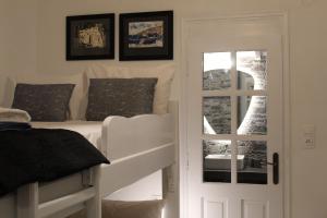 a bedroom with a bunk bed next to a door at Cycladic Villa in Amorgos Island (Maison Shiro) in Arkesíni