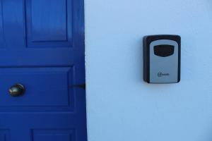 a blue door with a cell phone on it at Cycladic Villa in Amorgos Island (Maison Shiro) in Arkesíni